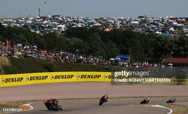 Supporters cheer in the stands during the qualifying session of the MotoGP German motorcycle Grand Prix at the Sachsenring racing circuit in...