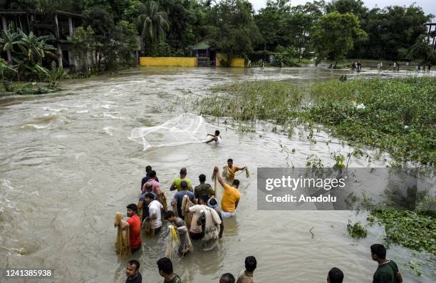 People fishing in the flood water after heavy rainfall, at a village on June 18, 2022 in Nalbari, India. Assam flood situation deteriorates due to...