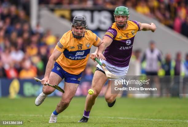 Tipperary , Ireland - 18 June 2022; Ian Galvin of Clare in action against Matthew O'Hanlon of Wexford during the GAA Hurling All-Ireland Senior...