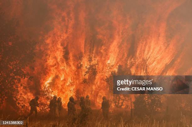 Firefighters operate at the site of a wildfire in Pumarejo de Tera near Zamora, northern Spain, on June 18, 2022. Firefighters continued to fight...