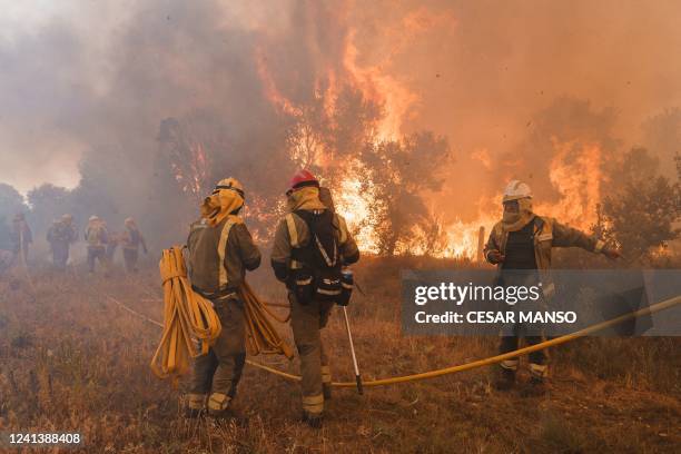 Firefighters operate at the site of a wildfire in Pumarejo de Tera near Zamora, northern Spain, on June 18, 2022. - Firefighters continued to fight...