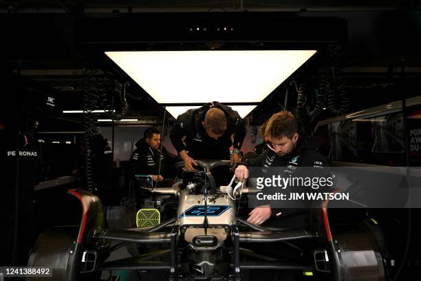 Pit crew works on the car of Mercedes' British driver George Russell ahead of the qualifying session for the Canada Formula 1 Grand Prix on June 18...