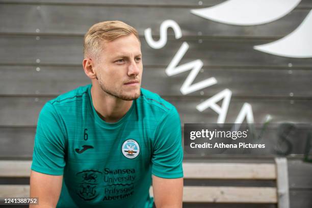 Harry Darling poses for a picture after signing a contract with Swansea City at the Fairwood Training Ground on June 18, 2022 in Swansea, Wales.