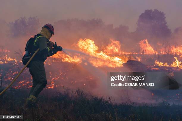 Firefighter operates at the site of a wildfire in Pumarejo de Tera near Zamora, northern Spain, on June 18, 2022. - Firefighters continued to fight...