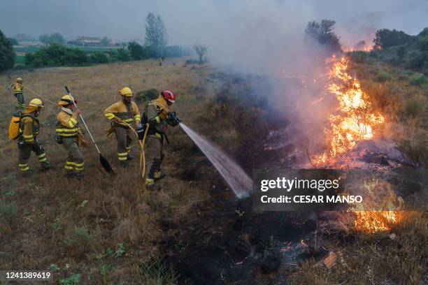 Firefighters operate at the site of a wildfire in Pumarejo de Tera near Zamora, northern Spain, on June 18, 2022. - Firefighters continued to fight...