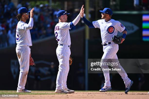 Andrelton Simmons, far left, Nico Hoerner, middle and Ian Happ, all of the Chicago Cubs celebrate a 6-3 win over the Atlanta Braves at Wrigley Field...