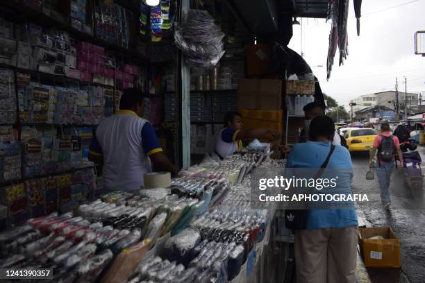 Shop owner awaits for customers while selling protective masks at the San Salvador Historical Center on June 18, 2022 in San Salvador, El Salvador....