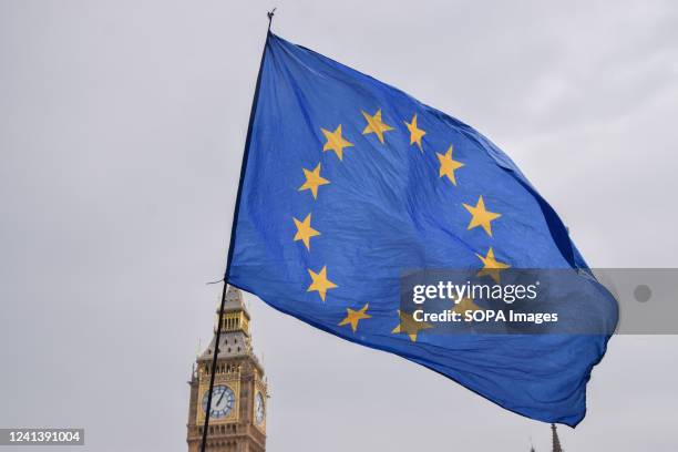 European Union flag is seen during the demonstration in Parliament Square. Thousands of people and various trade unions and groups marched through...