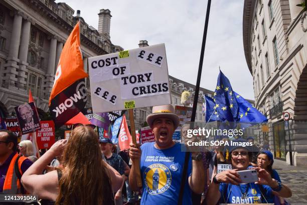 Anti-Brexit activist Steve Bray holds a placard which reads 'Cost of Tory crisis' during the demonstration in Regent Street. Thousands of people and...