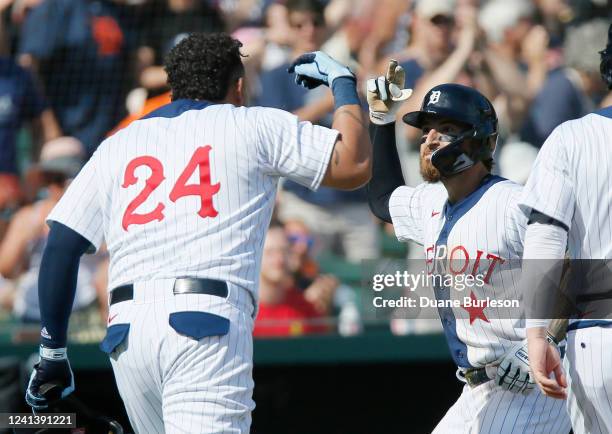 Eric Haase of the Detroit Tigers celebrates with Miguel Cabrera after hitting a three run home run that scored Cabrera during the fourth inning at...