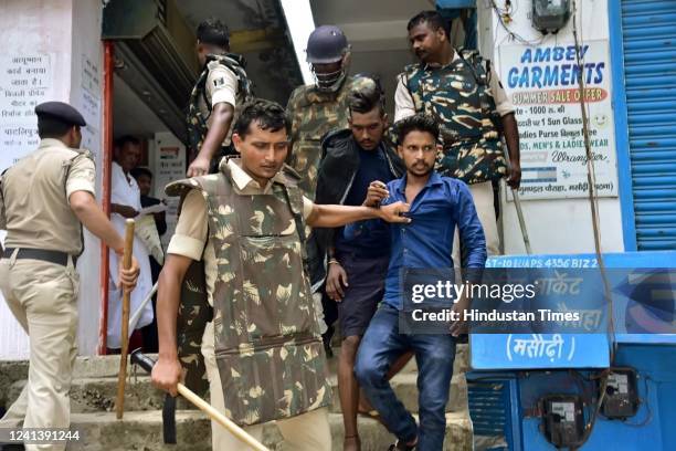Police detain protesters near Taregna Station in Masaurhi after the station was allegedly set on fire by protesters during Bihar Bandh to protest...