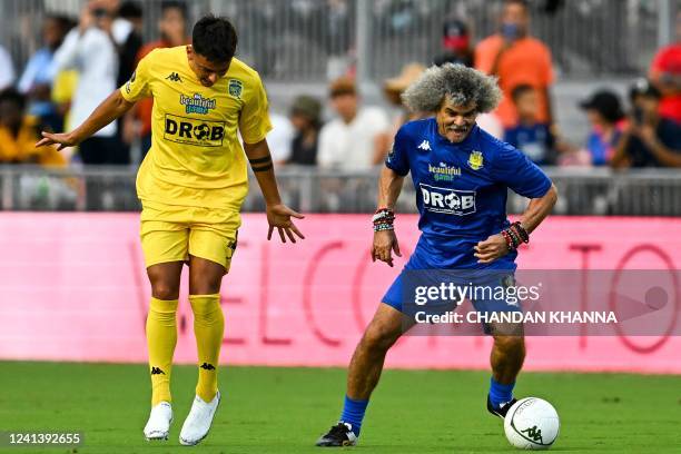 Colombian football player Carlos Valderrama controls the ball during "The Beautiful Game" a celebrity football match at DRV PNK stadium in Fort...