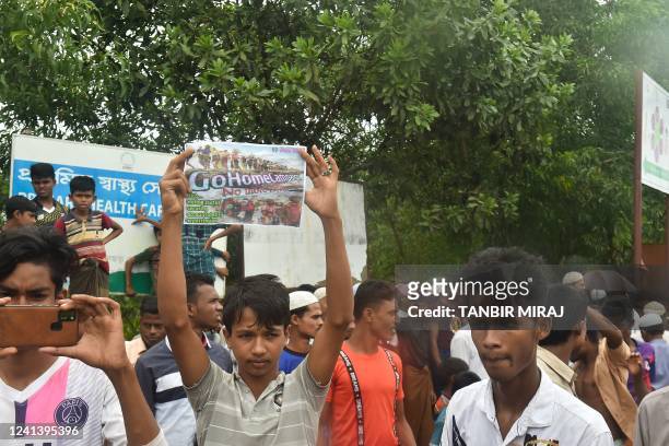 Rohingya refugees walk a "Go home campaign" rally demanding repatriation at Kutupalong Rohingya camp in Cox's Bazar on June 19, 2022. - Tens of...