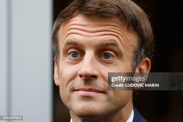 France's President Emmanuel Macron looks on as he arrives to vote in the second stage of French parliamentary elections at a polling station in Le...