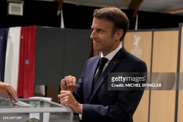 France's President Emmanuel Macron cast his vote during the second stage of French parliamentary elections at a polling station in Le Touquet,...