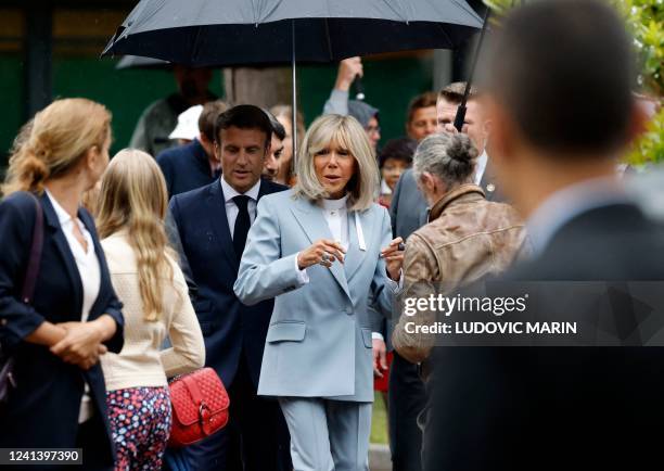 France's President Emmanuel Macron and his wife Brigitte Macron leave after casting their votes in the second stage of French parliamentary elections...