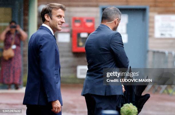 France's President Emmanuel Macron looks on as he leaves after casting his vote in the second stage of French parliamentary elections at a polling...
