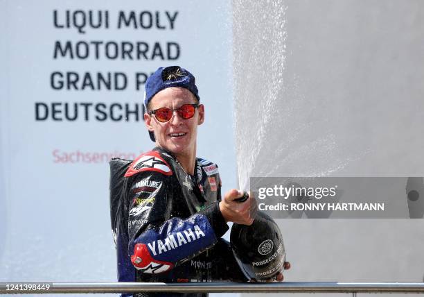 Monster Energy Yamaha's French rider Fabio Quartararo celebrates on the podium after winning the German MotoGP Grand Prix at the Sachsenring racing...