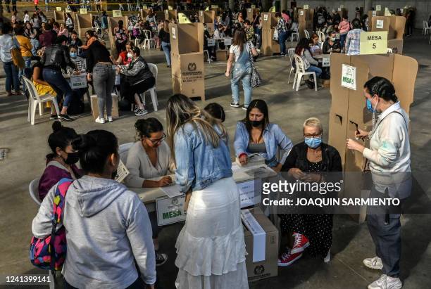 People vote at a polling station during the presidential runoff election in Medellin, Colombia, on June 19, 2022. - Colombians vote for a new...