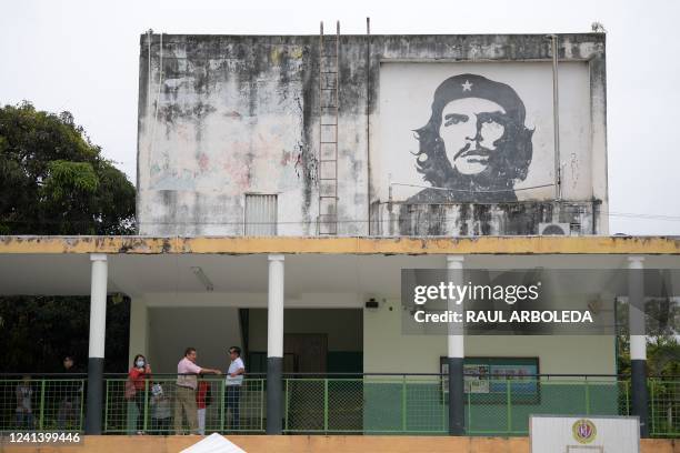 Voters queue at a polling station depicting an image of Argentine revolutionary leader Ernesto "Che" Guevara during the presidential runoff election...