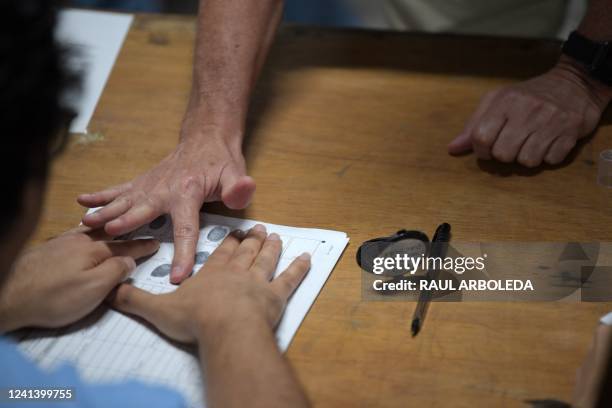 Person voting stamps the fingerprint at a polling station in Bucaramanga, Colombia, during the presidential runoff election on June 19, 2022. -...