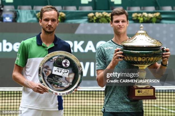 Poland's Hubert Hurkacz poses with the trophy next to Russia's Daniil Medvedev after winning the men's singles final match at the ATP 500 Halle Open...