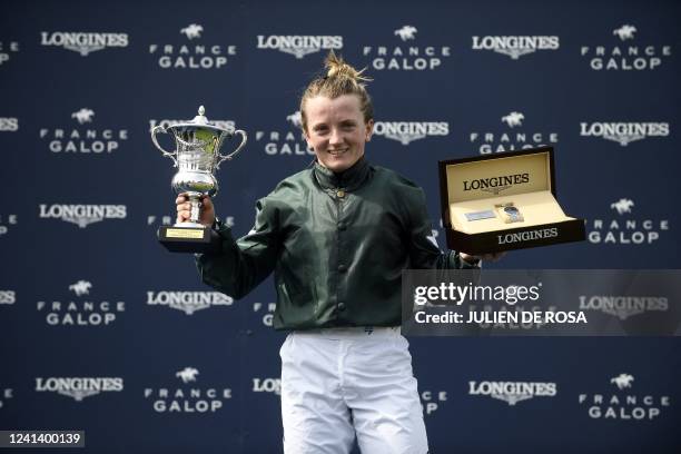 British jockey Hollie Doyle celebrates with her trophy after winning the Prix de Diane Group 1 horse race on Nashwa at Chantilly, north of Paris on...