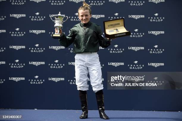 British jockey Hollie Doyle celebrates with her trophy after winning the Prix de Diane Group 1 horse race on Nashwa at Chantilly, north of Paris on...