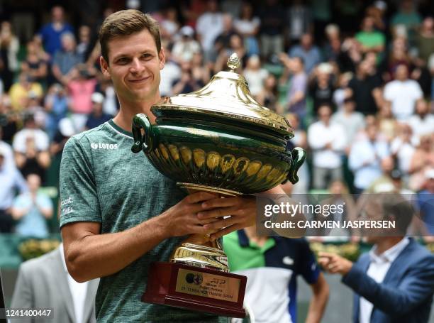 Poland's Hubert Hurkacz celebrates with the trophy after winning his singles final match against Russia's Daniil Medvedev at the ATP 500 Halle Open...