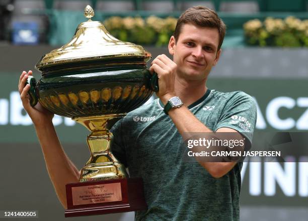 Poland's Hubert Hurkacz poses with the trophy after winning his singles final match against Russia's Daniil Medvedev at the ATP 500 Halle Open tennis...