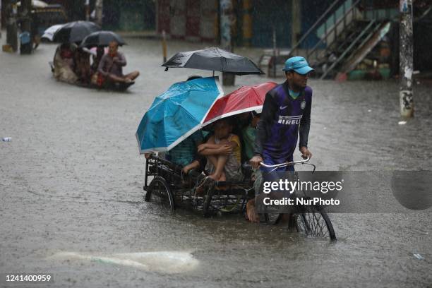 People try to survive as monsoon rains swamped huge areas of the country, leaving millions of homes underwater in Sylhet, Bangladesh on June 18,...