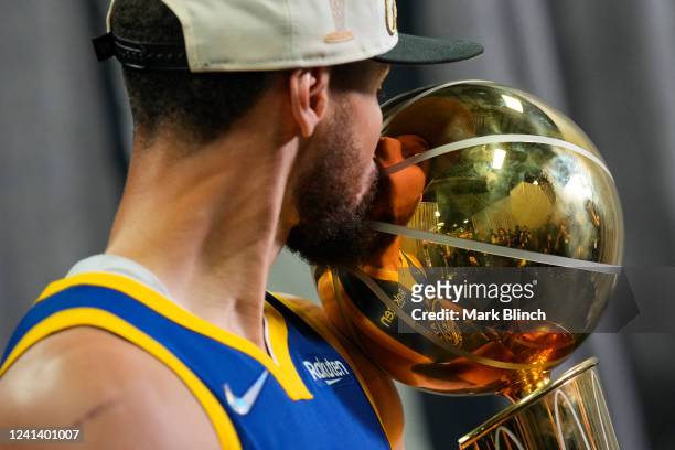 Stephen Curry of the Golden State Warriors poses for a portrait with the Larry O'Brien Championship Trophy after winning Game Six of the 2022 NBA...