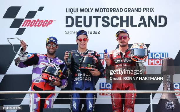 Second placed Ducati Pramac French rider Johann Zarco, first placed Monster Energy Yamaha's French rider Fabio Quartararo and third placed Ducati...