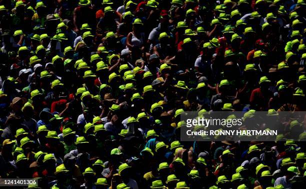 Supporters with yellow promotional caps of former Italian MotoGP driver Valentino Rossi are pictured in the stands during the German MotoGP Grand...