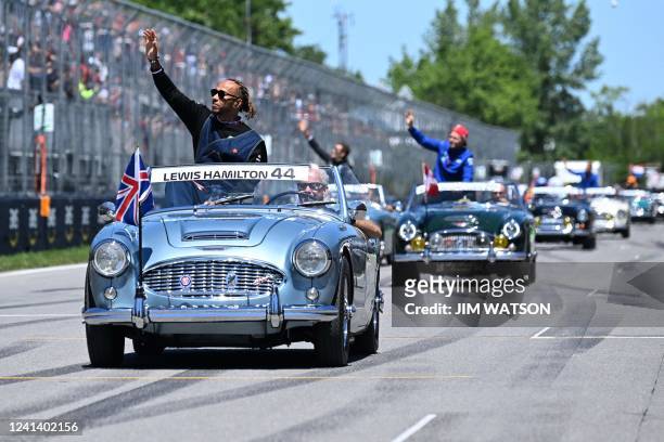 Mercedes' British driver Lewis Hamilton waves to the crowd during the parade of drivers, ahead of the Canada Formula 1 Grand Prix on June 19 at...