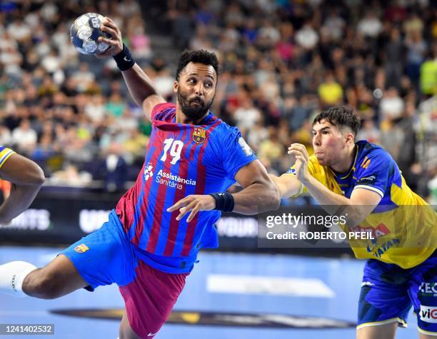 Barcelona's Timothey N'Guessan and Kielce's Daniel Dujshebaev vie for the ball during the EHF Men's Champions League Final Four final handball match...