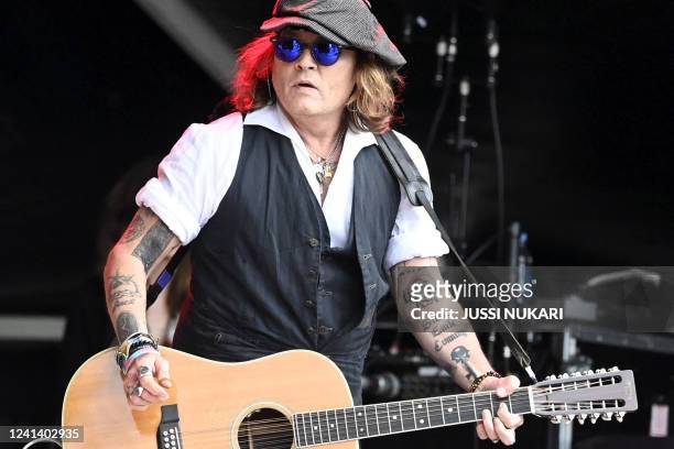 Johnny Depp performs on stage with Jeff Beck during the Helsinki Blues Festival in Helsinki on June 2022. / Finland OUT