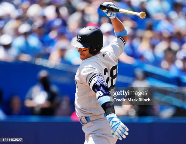 Josh Donaldson of the New York Yankees slams his bat after getting hit by a pitch against the Toronto Blue Jays in the first inning during their MLB...