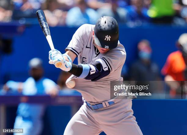 Josh Donaldson of the New York Yankees gets hit by a pitch against the Toronto Blue Jays in the first inning during their MLB game at the Rogers...