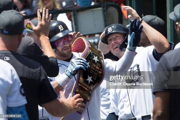 Robbie Grossman of the Detroit Tigers celebrates with Spencer Torkelson after hitting a three-run home run against the Texas Rangers during the first...