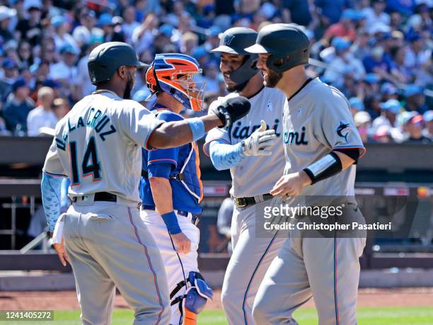 Jerar Encarnacion of the Miami Marlins is congratulated by teammate Bryan De La Cruz after hitting a grand slam in the top of the seventh inning...