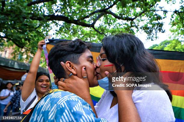 Young LGBT community members kiss during the Pride march. Lesbian, Gay, Bisexual and Transgender Pride Month is celebrated annually in June to honour...