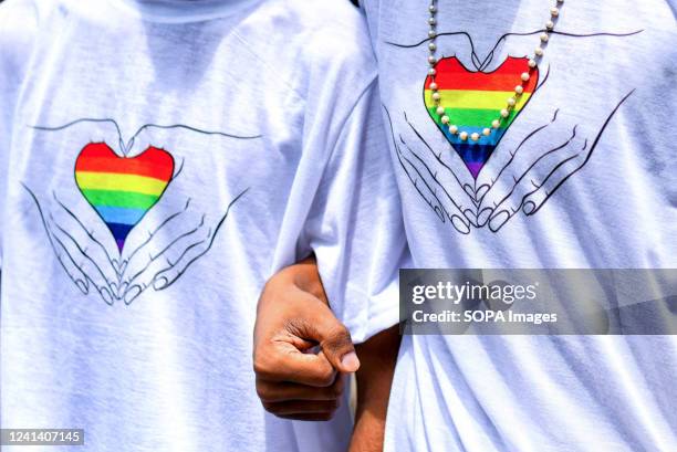 Young Gay couple of LGBT Community wear marching t shirts before the Pride march. Lesbian, Gay, Bisexual and Transgender Pride Month is celebrated...