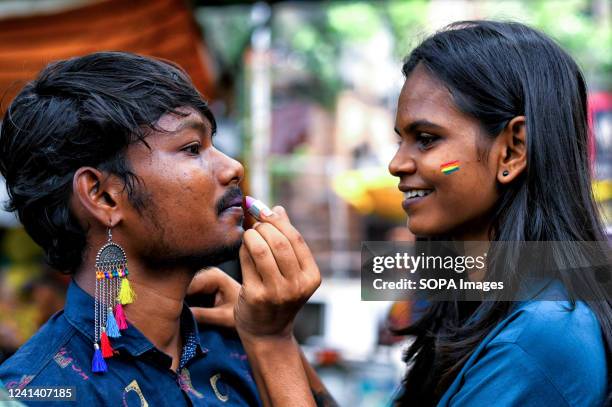 Young couple of the LGBT Community seen painting their faces with Pride Colors before the parade. Lesbian, Gay, Bisexual and Transgender Pride Month...