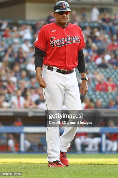 First base coach Sandy Alomar Jr. #15 of the Cleveland Guardians walks to first base during the third inning against the Kansas City Royals at...