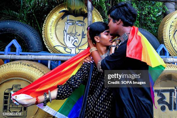 Young Gay couple of LGBT community members kiss during the Pride march. Lesbian, Gay, Bisexual and Transgender Pride Month is celebrated annually in...