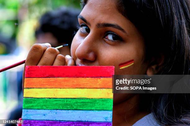 The LGBT Community member seen painting her face with Pride Colors before the parade. Lesbian, Gay, Bisexual and Transgender Pride Month is...