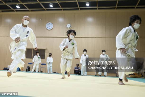 This photo taken on May 25, 2022 shows children taking part in a judo training session in Fukuroi, Shizuoka prefecture. - Japan is the home of judo...
