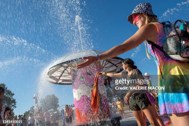 Festivalgoers refresh themselves from the heat during day 4 of the Bonnaroo Music and Arts Festival in Manchester, Tennessee, on June 19, 2022.