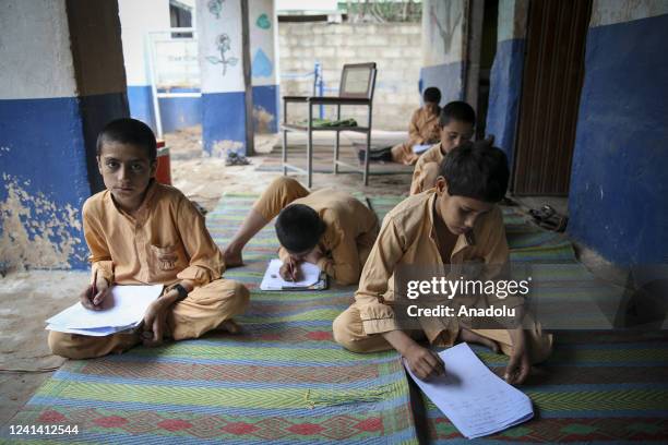 Afghani children are seen in a make-shift school in Islamabad, Pakistan on June 20, 2022. After the Soviet-Afghan War in 1979, the children of...